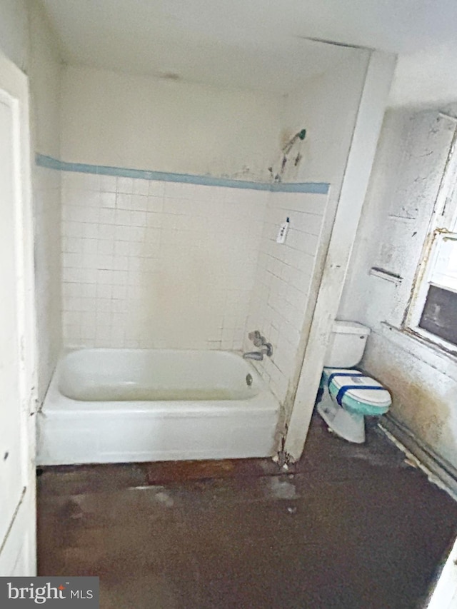 bathroom with toilet and bathing tub / shower combination