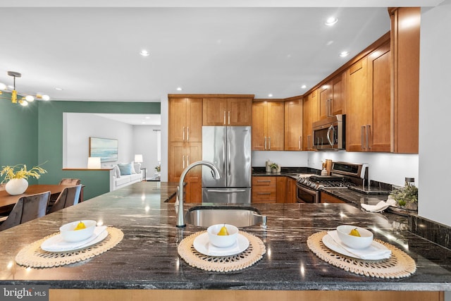 4906 Ertter Dr, Rockville, MD 20852 - kitchen featuring recessed lighting, brown cabinetry, a sink, dark stone countertops, and appliances with stainless steel finishes