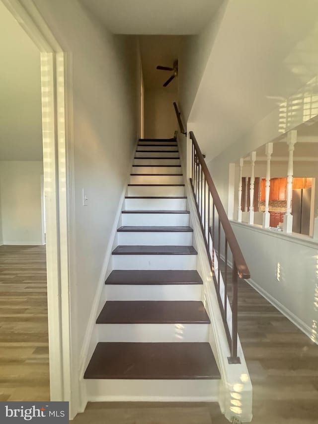 stairs featuring baseboards and wood finished floors