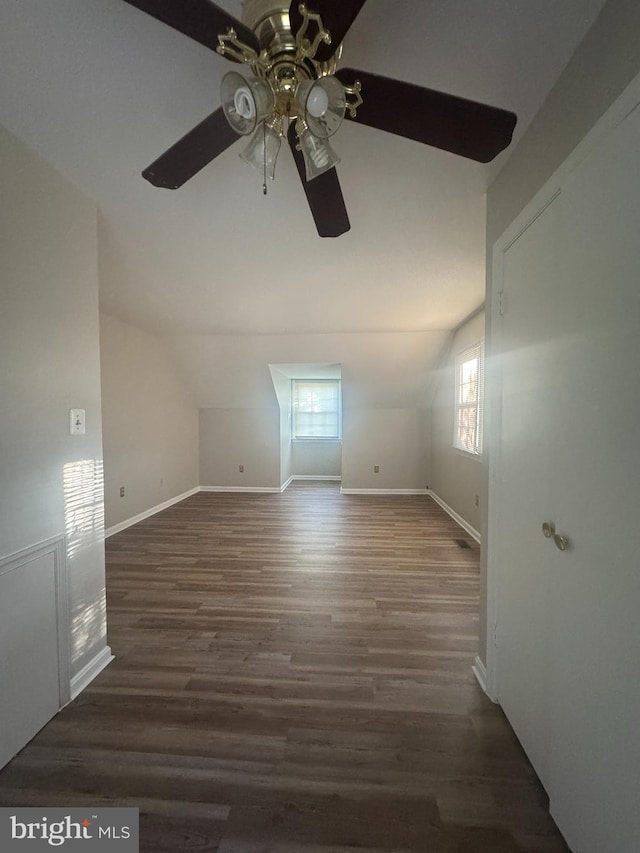additional living space with wood finished floors, baseboards, a ceiling fan, and lofted ceiling