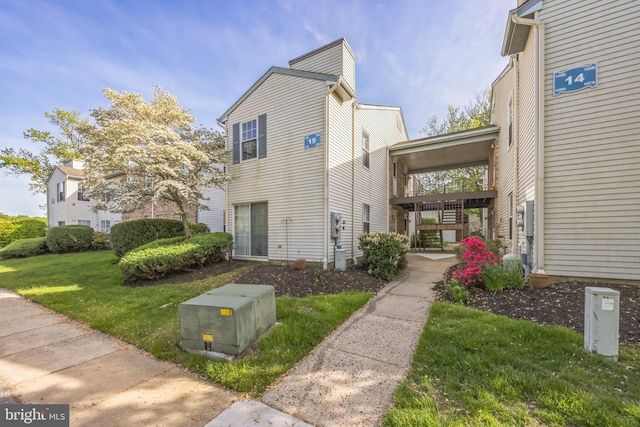 view of side of home featuring a lawn