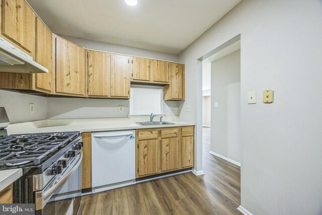 kitchen featuring dark wood-style flooring, stainless steel range with gas cooktop, light countertops, a sink, and dishwasher