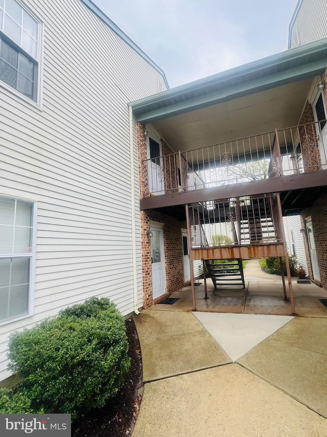 doorway to property featuring brick siding