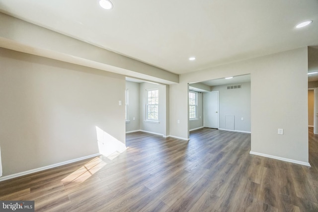 unfurnished living room featuring recessed lighting, baseboards, visible vents, and dark wood-style floors