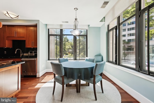 4301 Military Rd NW Unit 202, Washington, DC 20015 - dining space with baseboards, visible vents, a wealth of natural light, and dark wood finished floors