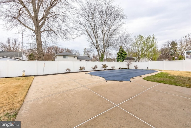 view of pool with a patio, a yard, a fenced backyard, and a fenced in pool