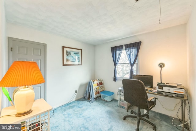 carpeted home office with a textured ceiling