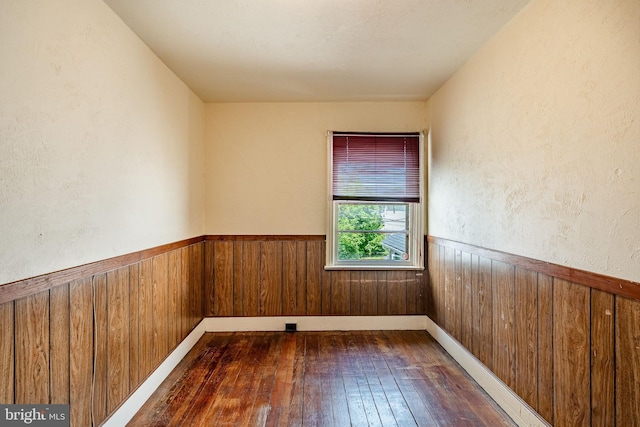 333 E Miner St, West Chester, PA 19382 - unfurnished room with dark wood-style flooring, wooden walls, and a wainscoted wall