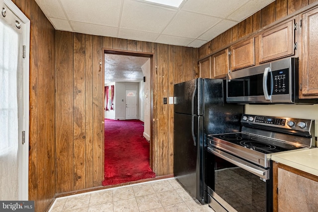 333 E Miner St, West Chester, PA 19382 - kitchen with appliances with stainless steel finishes, wooden walls, brown cabinets, light countertops, and baseboards