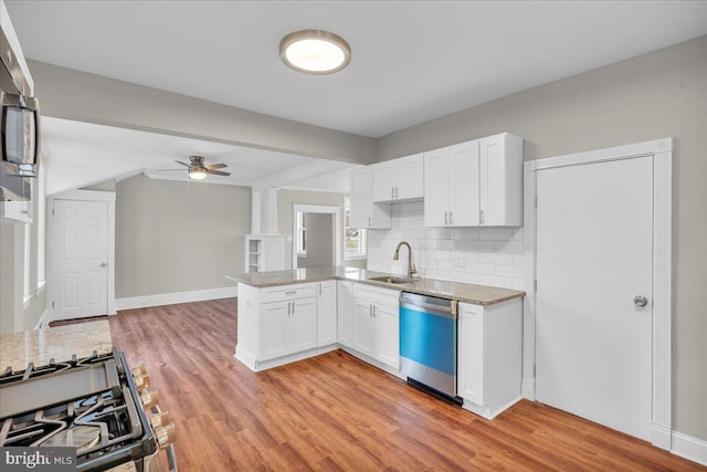 905 Cooper, Edgewater Park, NJ 08010 - kitchen featuring a sink, ceiling fan, a peninsula, light stone countertops, and dishwashing machine