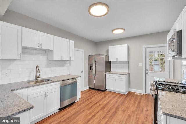 905 Cooper, Edgewater Park, NJ 08010 - kitchen featuring white cabinets, appliances with stainless steel finishes, and a sink