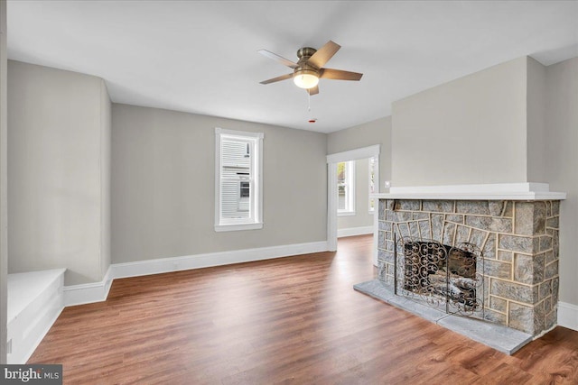 905 Cooper, Edgewater Park, NJ 08010 - unfurnished living room featuring wood finished floors, a ceiling fan, baseboards, and a stone fireplace