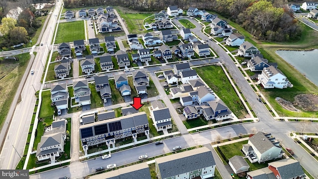 drone / aerial view with a water view and a residential view