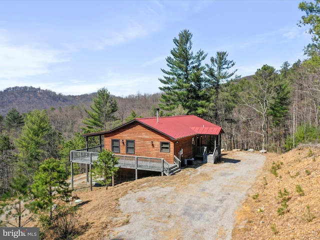 2201 Mill Gap Rd, Lost City, WV 26810 - view of side of property with a wooded view, central air condition unit, driveway, a deck with mountain view, and faux log siding