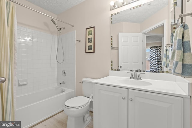 bathroom with vanity, a textured ceiling, toilet, and shower / bathtub combination with curtain