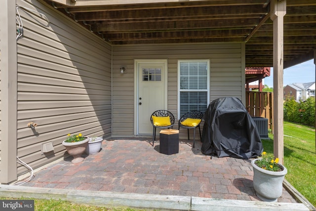 view of patio featuring central AC unit and a grill