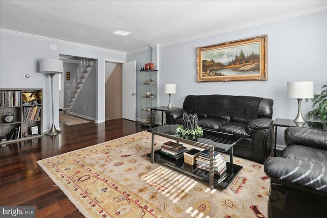 living area with baseboards, wood finished floors, ornamental molding, and stairway