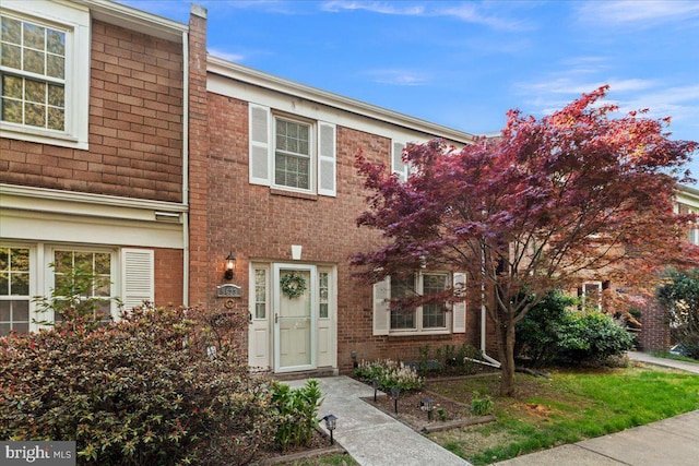 townhome / multi-family property featuring brick siding