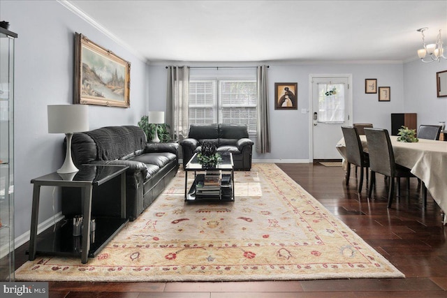 living room with baseboards, wood finished floors, a chandelier, and ornamental molding