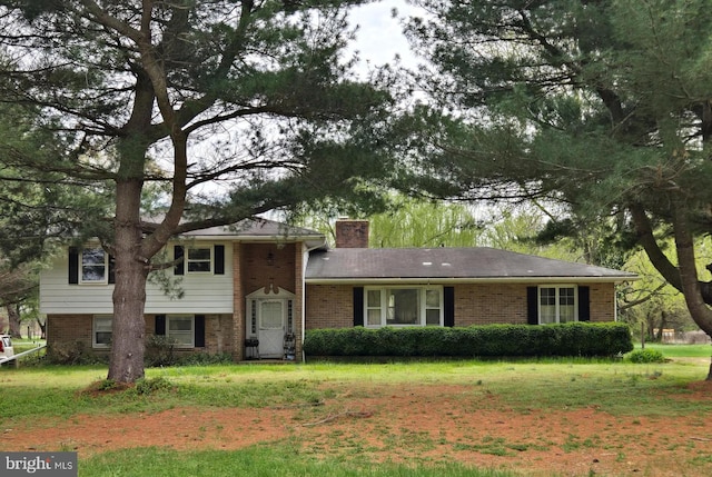 938 Church Hill Rd, Milford, DE 19963 - tri-level home featuring a chimney, a front yard, and brick siding