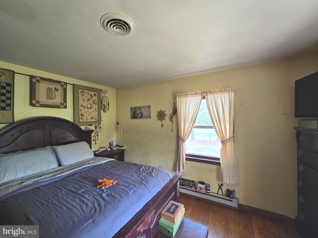 938 Church Hill Rd, Milford, DE 19963 - bedroom featuring baseboard heating, wood finished floors, and visible vents