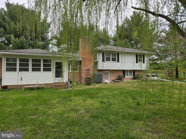 938 Church Hill Rd, Milford, DE 19963 - back of property with cooling unit, a chimney, and a lawn