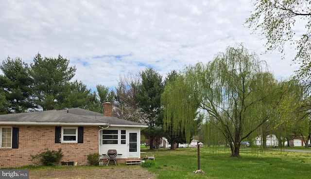 938 Church Hill Rd, Milford, DE 19963 - rear view of house featuring a chimney, brick siding, and a lawn