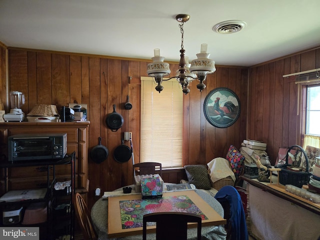 938 Church Hill Rd, Milford, DE 19963 - dining area with visible vents, a notable chandelier, and wood walls