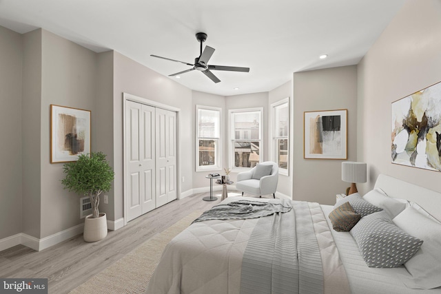 bedroom with a closet, baseboards, recessed lighting, light wood-style floors, and visible vents