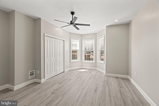 unfurnished bedroom featuring visible vents, baseboards, a closet, light wood-type flooring, and recessed lighting