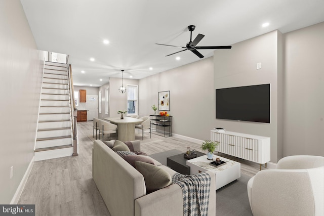 living area with recessed lighting, stairway, and light wood finished floors