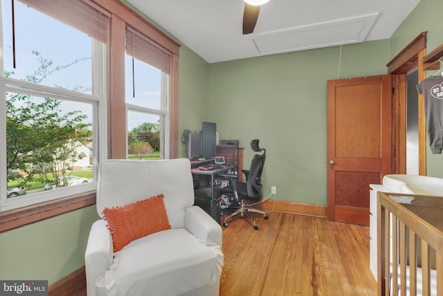 office area featuring baseboards, attic access, and light wood-style floors