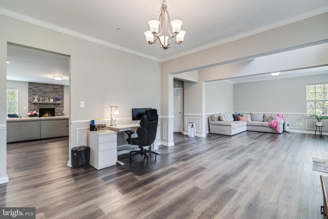 13301 Windjammer Ct, Hughesville, MD 20637 - office space featuring a wainscoted wall, an inviting chandelier, a stone fireplace, ornamental molding, and dark wood-type flooring