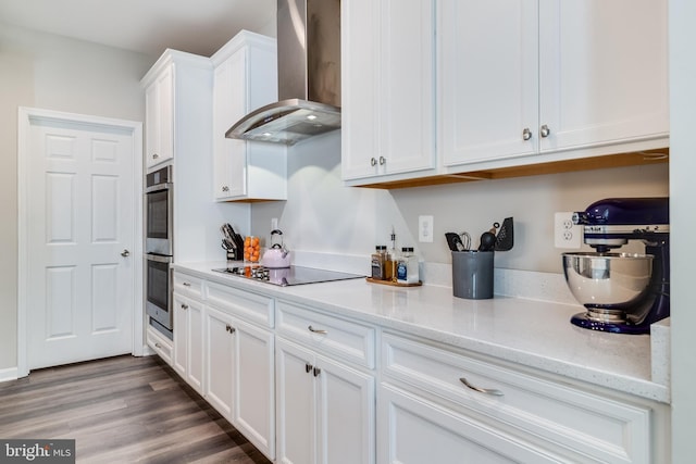 13301 Windjammer Ct, Hughesville, MD 20637 - kitchen featuring wall chimney range hood, double oven, black electric cooktop, white cabinetry, and light stone countertops
