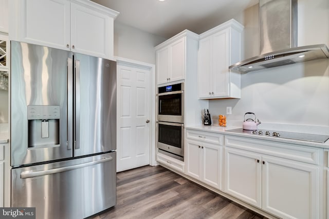 13301 Windjammer Ct, Hughesville, MD 20637 - kitchen with white cabinets, wall chimney exhaust hood, stainless steel appliances, and light countertops