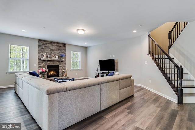 13301 Windjammer Ct, Hughesville, MD 20637 - living area featuring a fireplace, wood finished floors, stairs, and baseboards