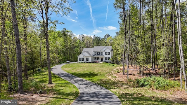 13301 Windjammer Ct, Hughesville, MD 20637 - view of front of house featuring covered porch, a wooded view, and a front yard