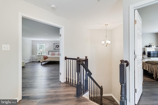 13301 Windjammer Ct, Hughesville, MD 20637 - hall with baseboards, a chandelier, an upstairs landing, and dark wood finished floors