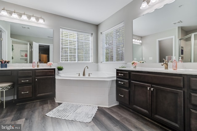 13301 Windjammer Ct, Hughesville, MD 20637 - bathroom featuring a bath, a sink, a stall shower, visible vents, and wood finished floors