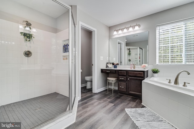 13301 Windjammer Ct, Hughesville, MD 20637 - full bathroom with wood finished floors, toilet, vanity, a bath, and a stall shower