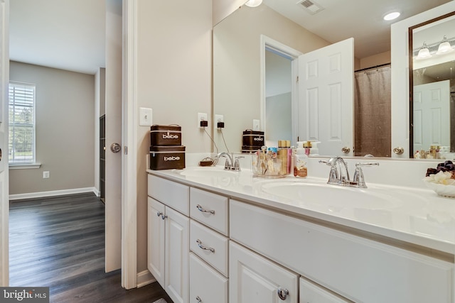 13301 Windjammer Ct, Hughesville, MD 20637 - full bathroom with wood finished floors, a sink, visible vents, and double vanity