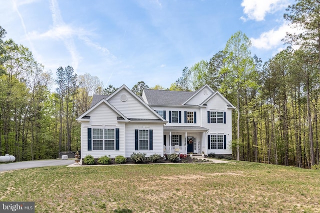 13301 Windjammer Ct, Hughesville, MD 20637 - traditional home featuring a shingled roof, a front yard, and covered porch