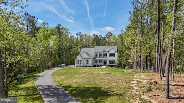 13301 Windjammer Ct, Hughesville, MD 20637 - view of front of home with a view of trees, driveway, and a front lawn