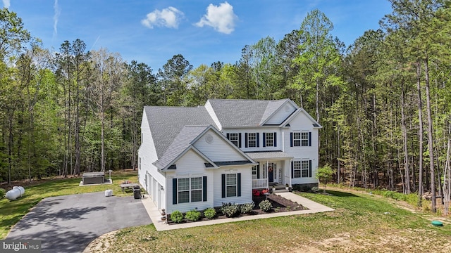 13301 Windjammer Ct, Hughesville, MD 20637 - traditional home with a view of trees, driveway, a shingled roof, and a front yard