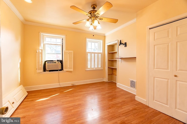 2631 W Gordon St, Philadelphia, PA 19132 - unfurnished bedroom with light wood-style floors, crown molding, cooling unit, a ceiling fan, and baseboards