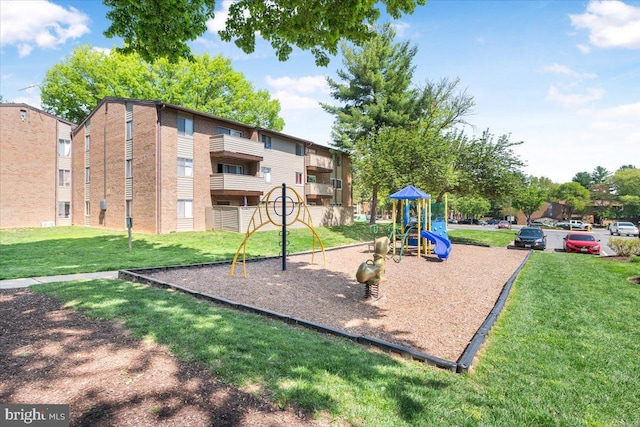 community jungle gym featuring a yard