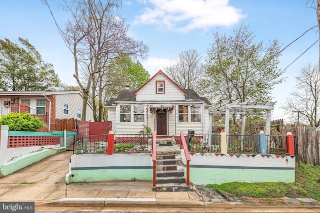 bungalow-style home featuring a fenced front yard