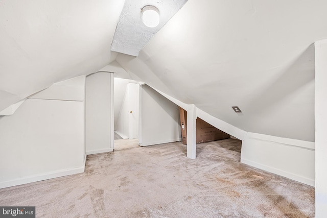 additional living space with carpet floors and lofted ceiling