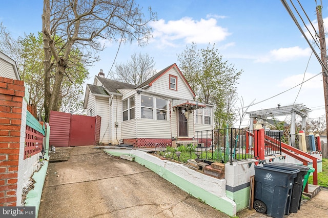 view of front of home with fence and a chimney