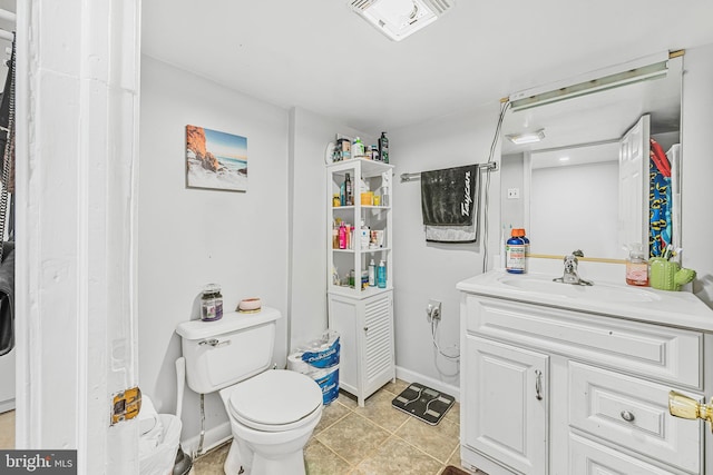 bathroom featuring vanity, tile patterned flooring, visible vents, toilet, and baseboards